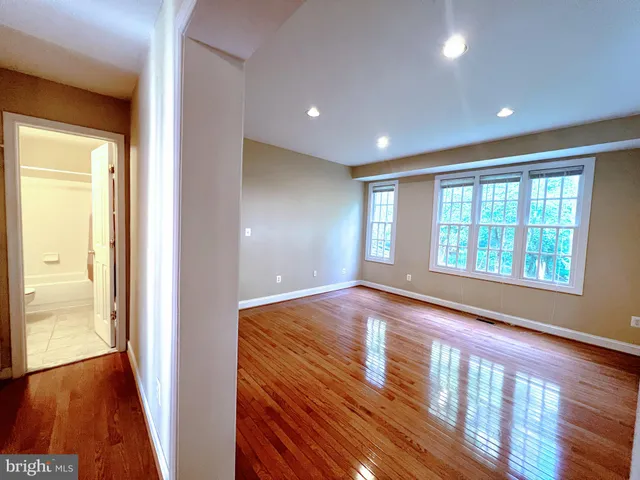 a bathroom with a bathtub shower sink vanity and toilet