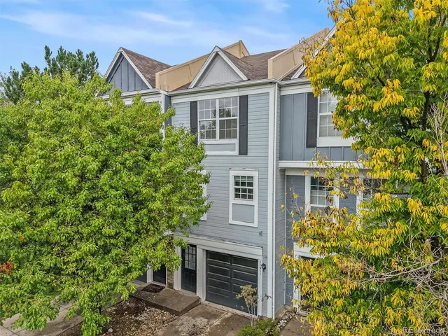 front view of a house with a tree