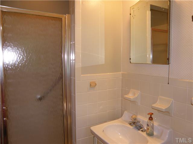 5121 Wickham Road Raleigh, NC 27606 - Photo 16 of 21 a bathroom with a sink a toilet and shower