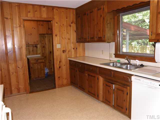 5121 Wickham Road Raleigh, NC 27606 - Photo 6 of 21 a kitchen with a sink and a refrigerator
