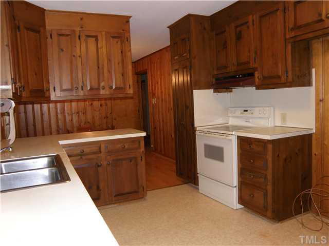 5121 Wickham Road Raleigh, NC 27606 - Photo 7 of 21 a kitchen with a sink a stove and a microwave oven
