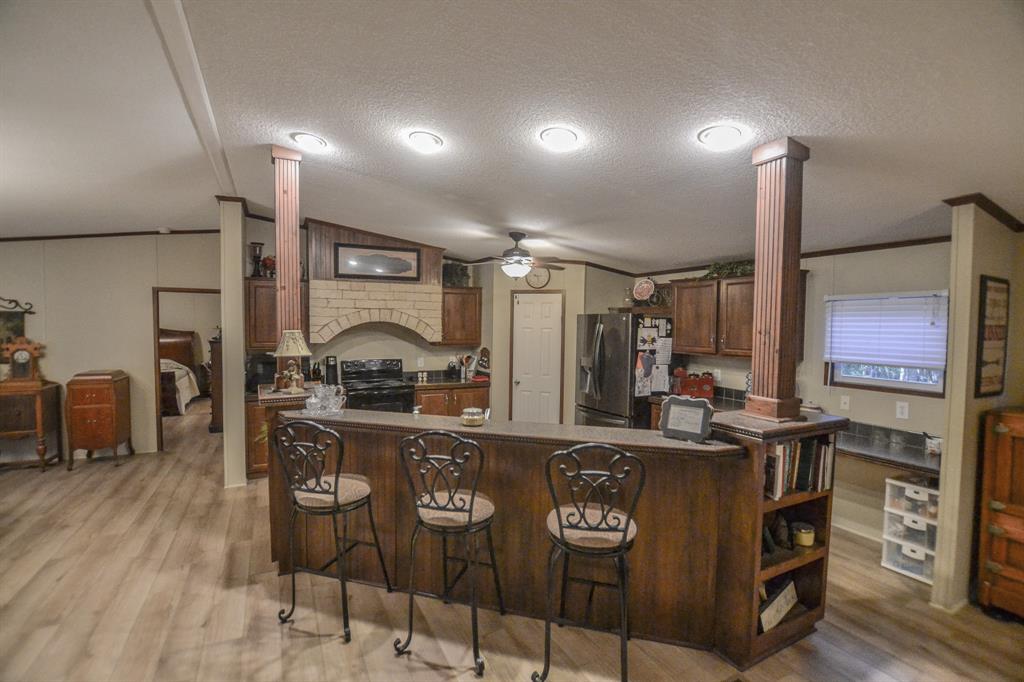 0 County Road 3409 Chandler, TX 75758 - Photo 13 of 38 a kitchen with stainless steel appliances granite countertop a stove and cabinets