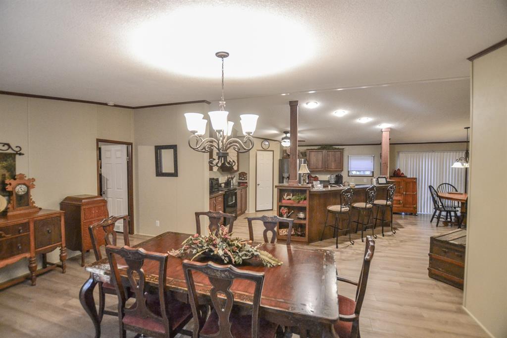0 County Road 3409 Chandler, TX 75758 - Photo 14 of 38 a view of a dining room and livingroom with furniture wooden floor a chandelier