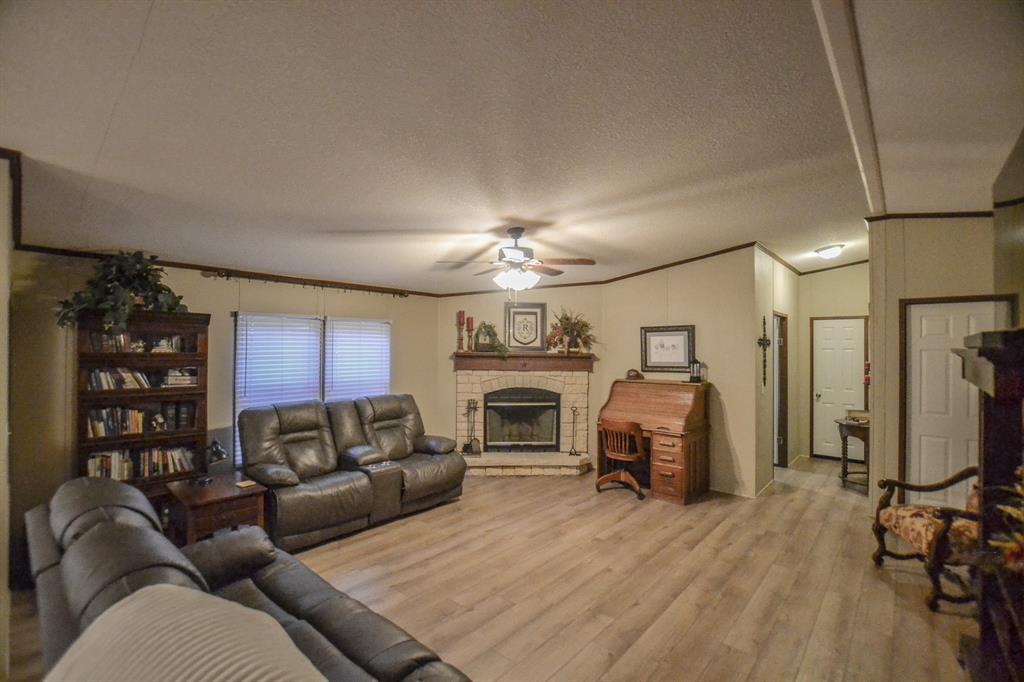 0 County Road 3409 Chandler, TX 75758 - Photo 16 of 38 a living room with furniture a fireplace and a flat screen tv