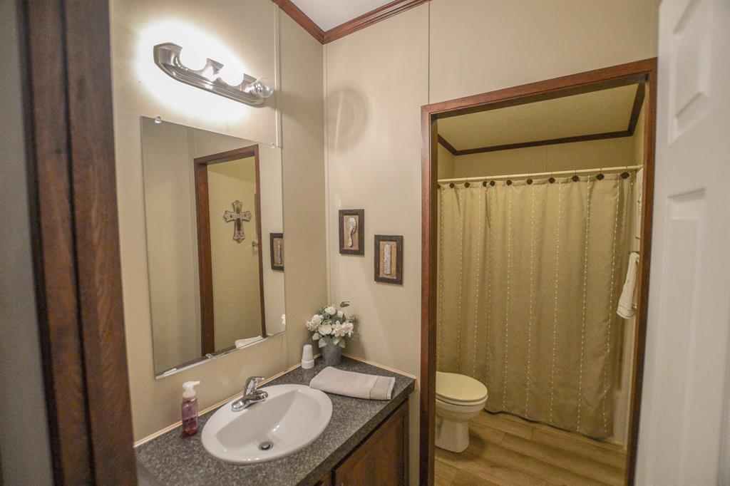 0 County Road 3409 Chandler, TX 75758 - Photo 24 of 38 a bathroom with a granite countertop sink toilet and shower