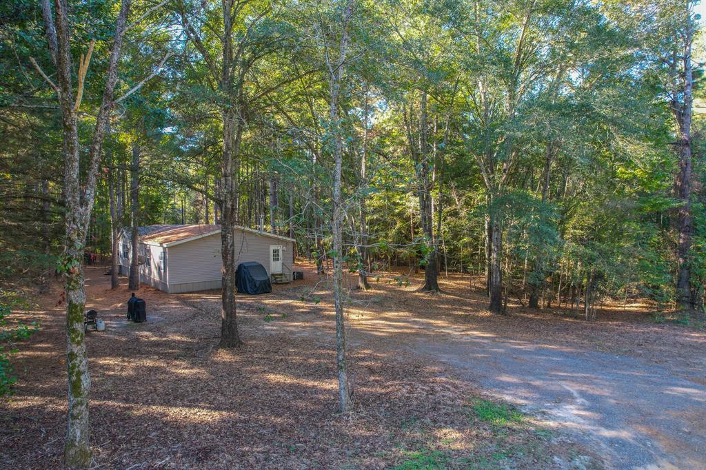 0 County Road 3409 Chandler, TX 75758 - Photo 10 of 38 a front view of a house with a yard and garage