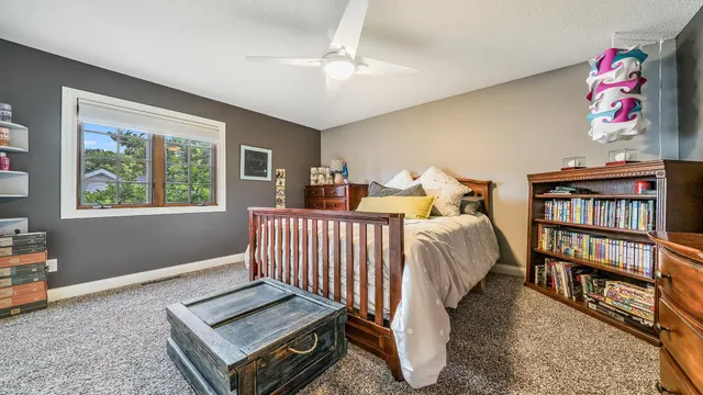 a bedroom with furniture and a book shelf