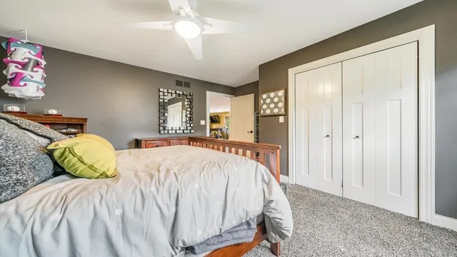 a bed sitting in a bedroom and chandelier
