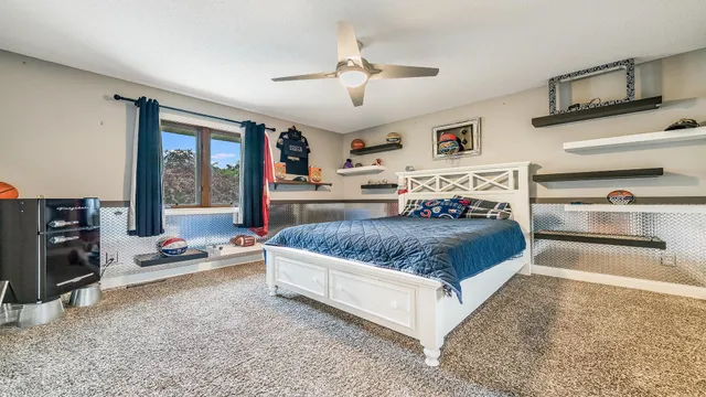 a bedroom with a large bed and a window