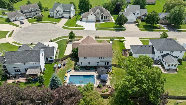 an aerial view of multiple houses with yard