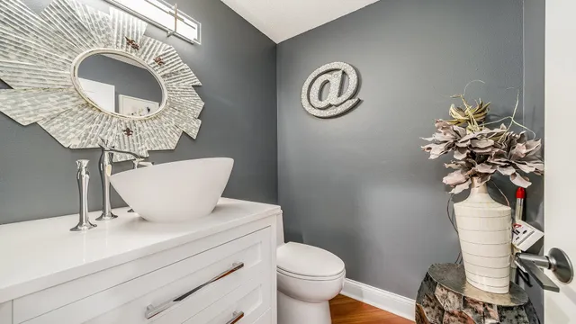 a bathroom with a toilet a sink and mirror