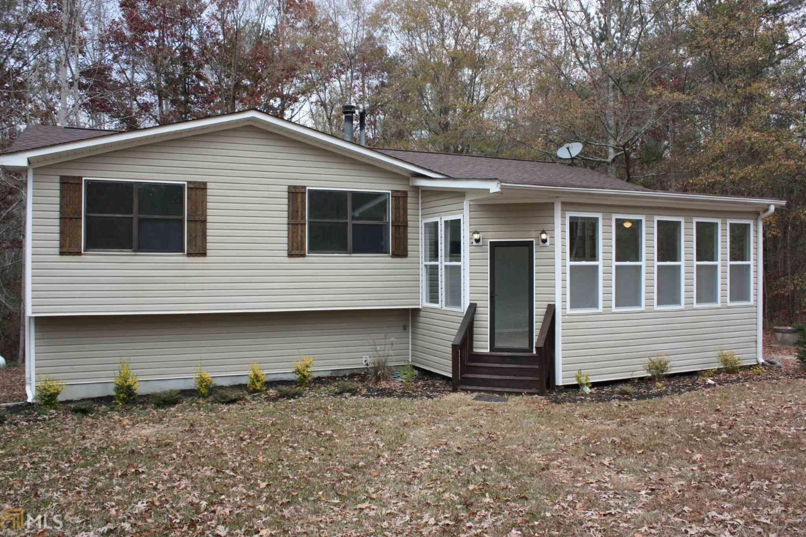 a front view of a house with a wooden deck