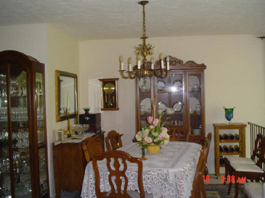 5728 Spring Brook Road Rockford, IL 61114 - Photo 2 of 6 a view of a dining room with furniture and chandelier