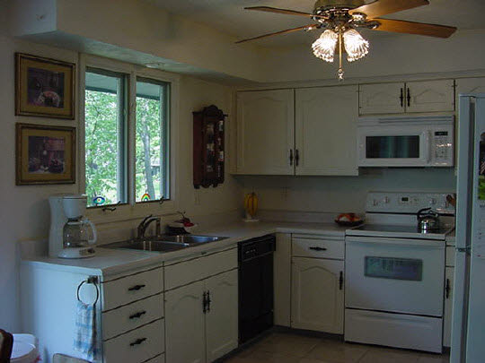 5728 Spring Brook Road Rockford, IL 61114 - Photo 3 of 6 a kitchen with stainless steel appliances granite countertop a sink a stove and a microwave