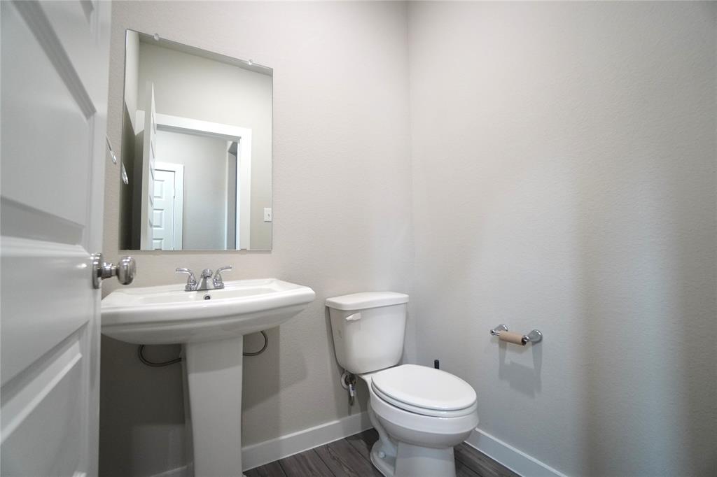 2512 Green River Road Royse City, TX 75189 - Photo 2 of 13 a bathroom with a toilet sink and mirror