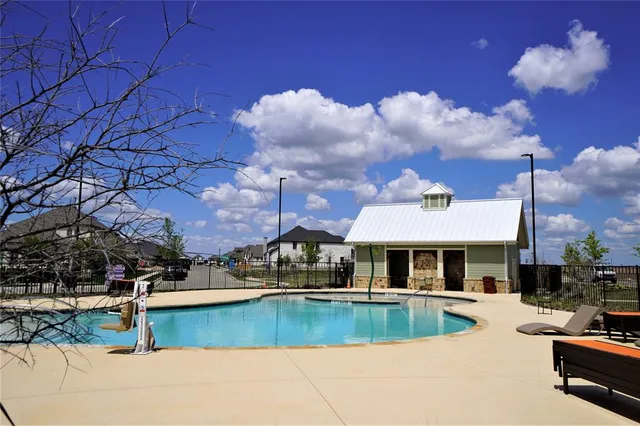 a view of a house with swimming pool and sitting area