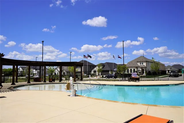 a view of a swimming pool with a table and chairs