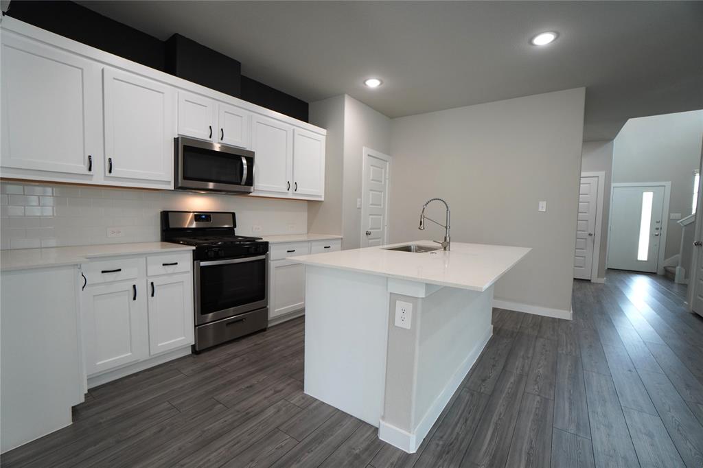 2512 Green River Road Royse City, TX 75189 - Photo 4 of 13 a kitchen with a sink a microwave and cabinets