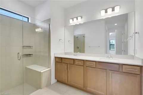 a bathroom with a sink double vanity and a mirror