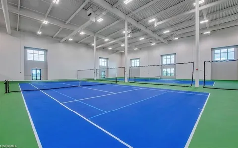 a room with pool table and windows