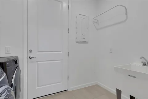 a view of a storage & utility room with a sink
