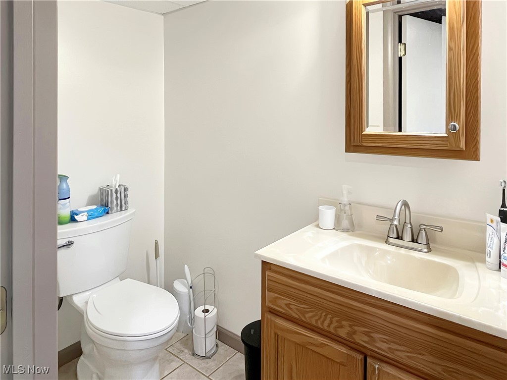 3968 Cannon Road Youngstown, OH 44515 - Photo 17 of 25 Half bath featuring vanity and light tile patterned flooring