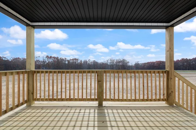 a view of a balcony with a floor to ceiling window with wooden fence