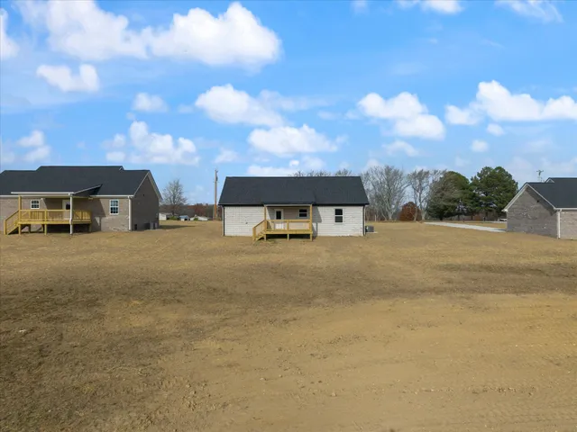 a front view of a house with a yard and balcony