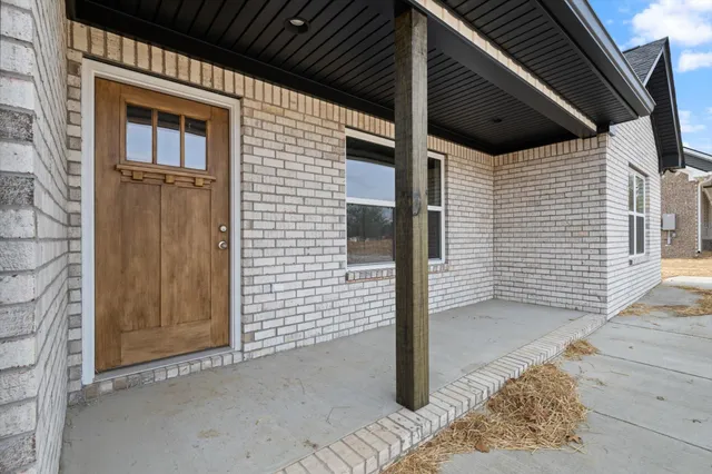 a view of a house with a door and wooden roof