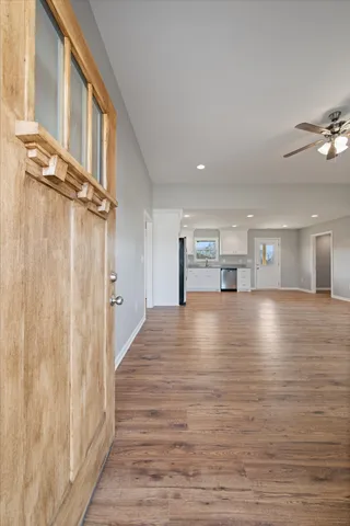 a view of empty room with wooden floor