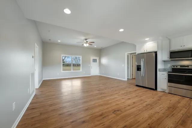 a view of a kitchen with a sink and a refrigerator
