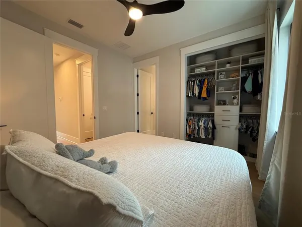 a bedroom with a bed and a chandelier