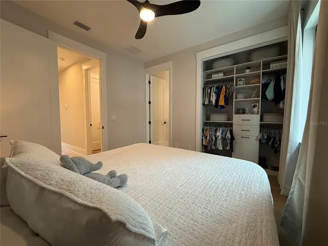 a bedroom with a bed and a chandelier
