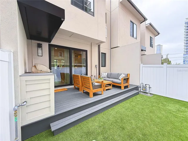 a view of a house with backyard porch and wooden floor
