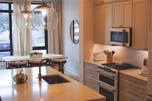 a kitchen with stainless steel appliances granite countertop a stove and a microwave