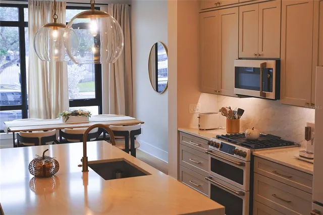 a kitchen with stainless steel appliances granite countertop a stove and a microwave
