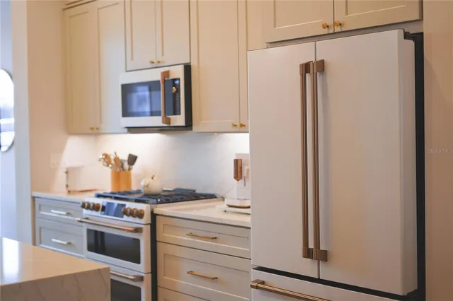a kitchen with appliances a sink and cabinets