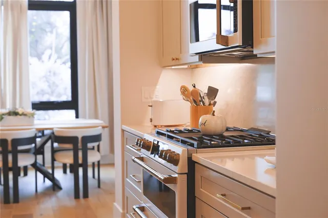 a stove top oven sitting inside of a kitchen