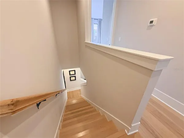 a view of a hallway with stairs