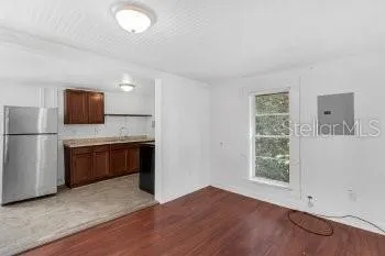 a kitchen with a refrigerator and a stove top oven