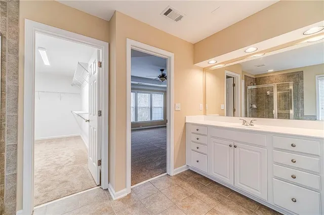 an empty room with a cabinet and mirrors