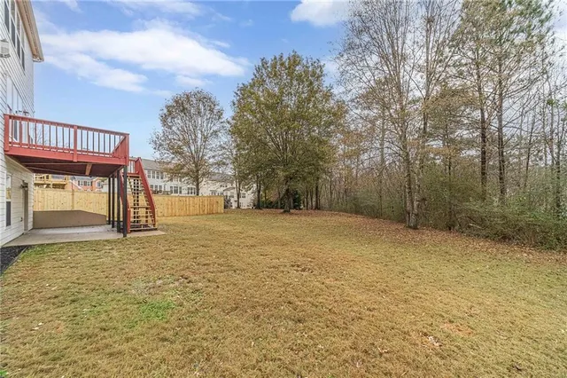 a view of a hallway with wooden floor and entryway