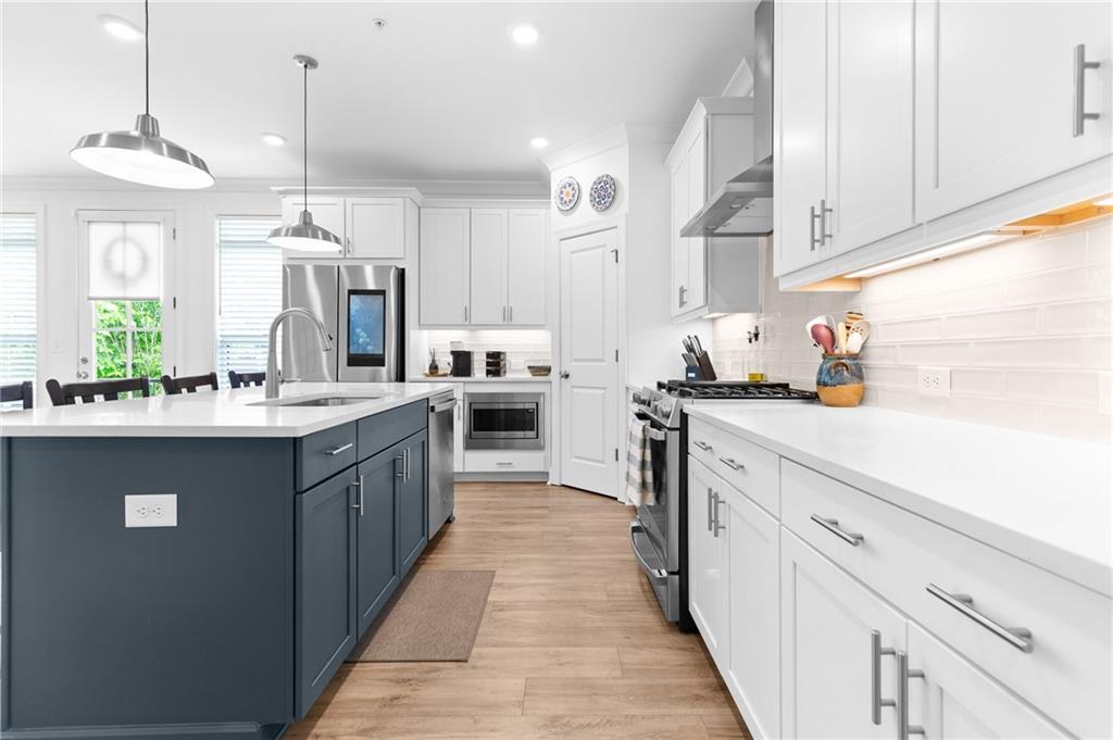 300 Olmstead Way Alpharetta, GA 30022 - Photo 14 of 52 a kitchen with kitchen island granite countertop a sink a counter top space stainless steel appliances and cabinets