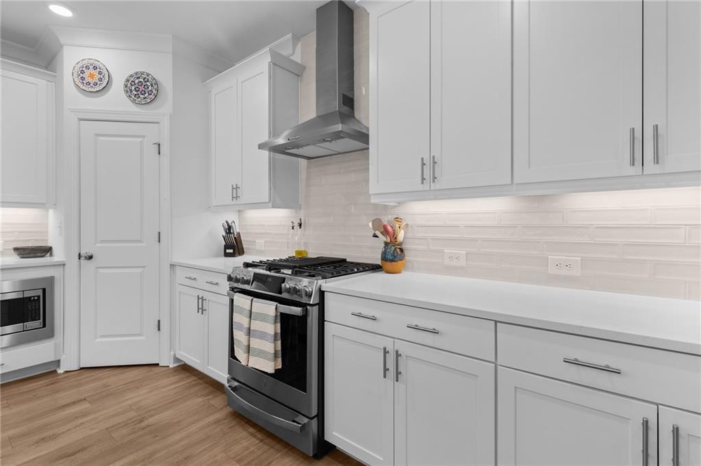 300 Olmstead Way Alpharetta, GA 30022 - Photo 15 of 52 a kitchen with granite countertop white cabinets and white appliances