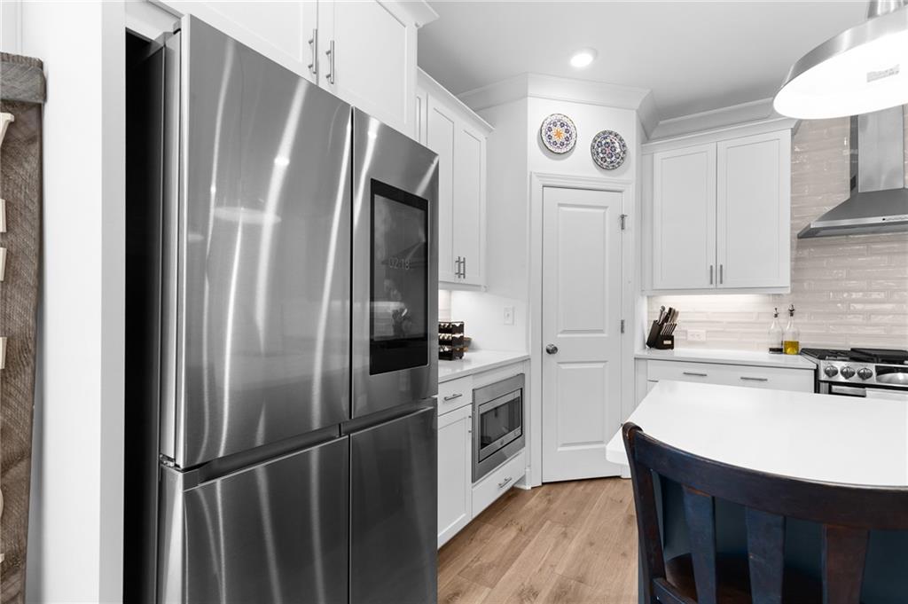 300 Olmstead Way Alpharetta, GA 30022 - Photo 16 of 52 a kitchen with a refrigerator a sink and cabinets