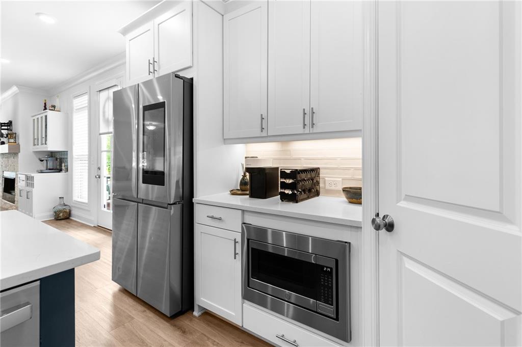 300 Olmstead Way Alpharetta, GA 30022 - Photo 17 of 52 a kitchen with stainless steel appliances a stove a refrigerator and cabinets