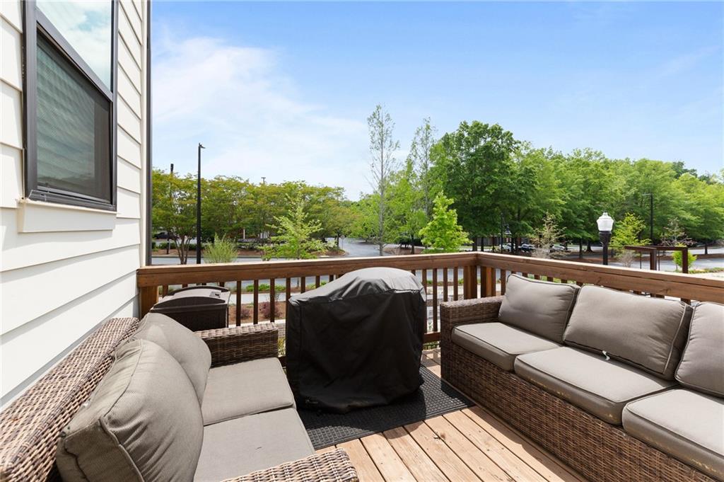 300 Olmstead Way Alpharetta, GA 30022 - Photo 25 of 52 a balcony with wooden floor and outdoor seating