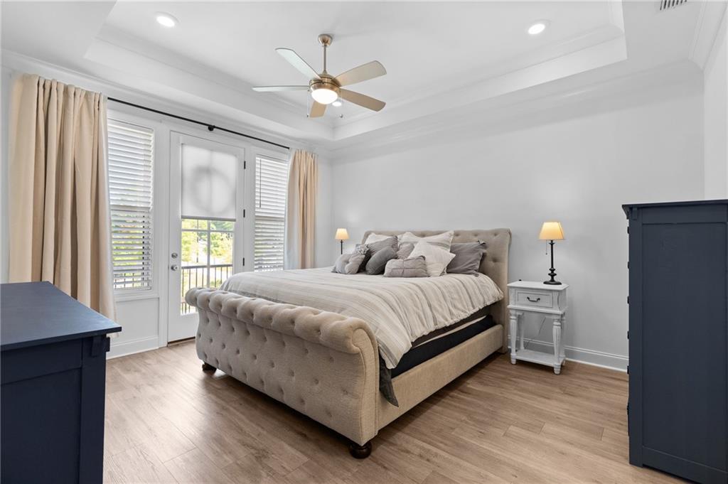 300 Olmstead Way Alpharetta, GA 30022 - Photo 29 of 52 a bedroom with a large bed chandelier and a window