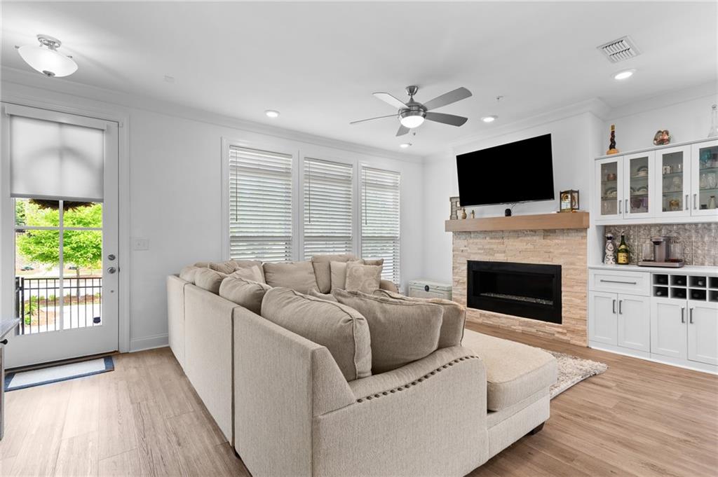 300 Olmstead Way Alpharetta, GA 30022 - Photo 3 of 52 a living room with furniture a fireplace and a flat screen tv