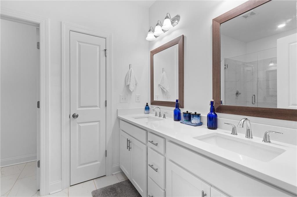 300 Olmstead Way Alpharetta, GA 30022 - Photo 33 of 52 a bathroom with double vanity sinks and a mirror